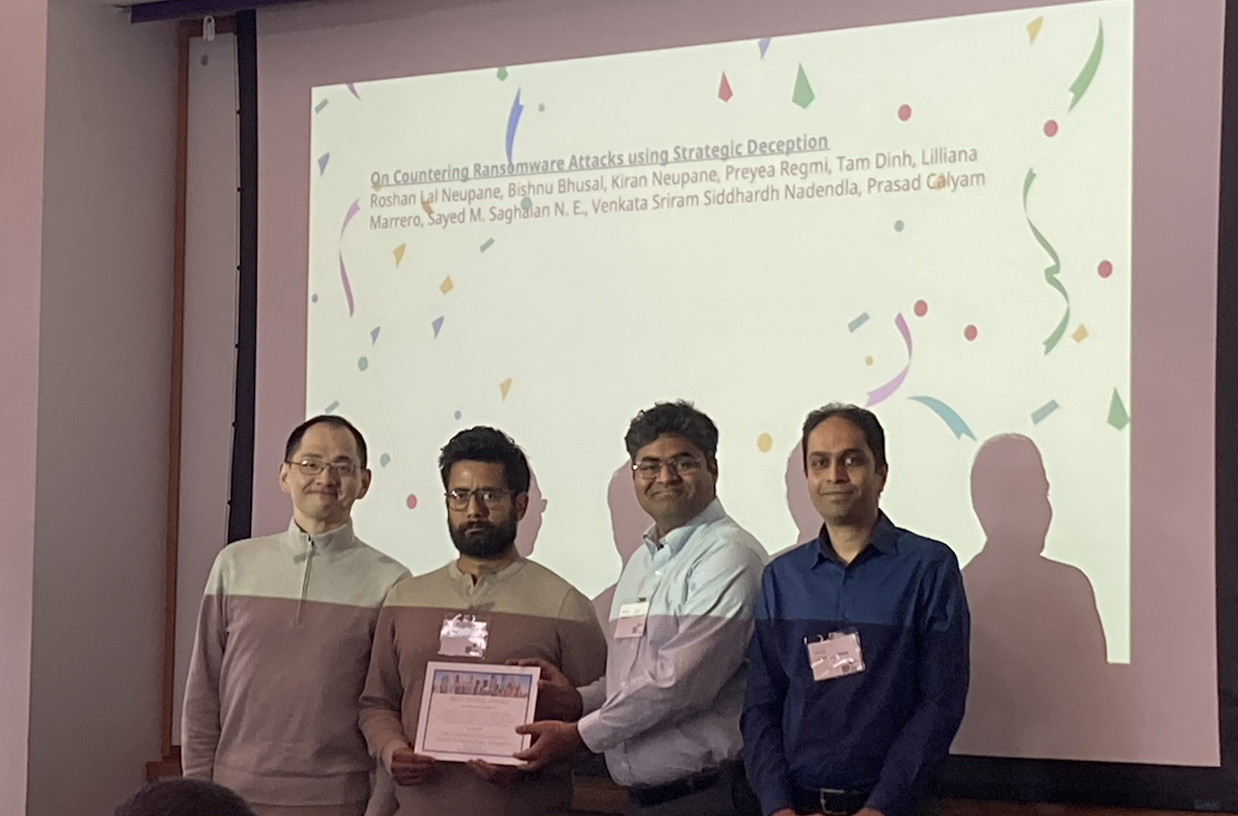 Roshan and Dr. Sid receiving the best paper award at GameSec 2024